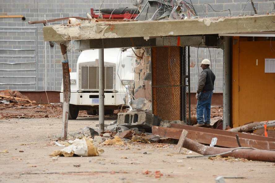 A construction worker watches the demolition of the old base exchange at Shaw Air Force Base, S.C., Dec.12, 2012.  (U.S. Air Force photo by Airman 1st Class Nicole Sikorski/Released)