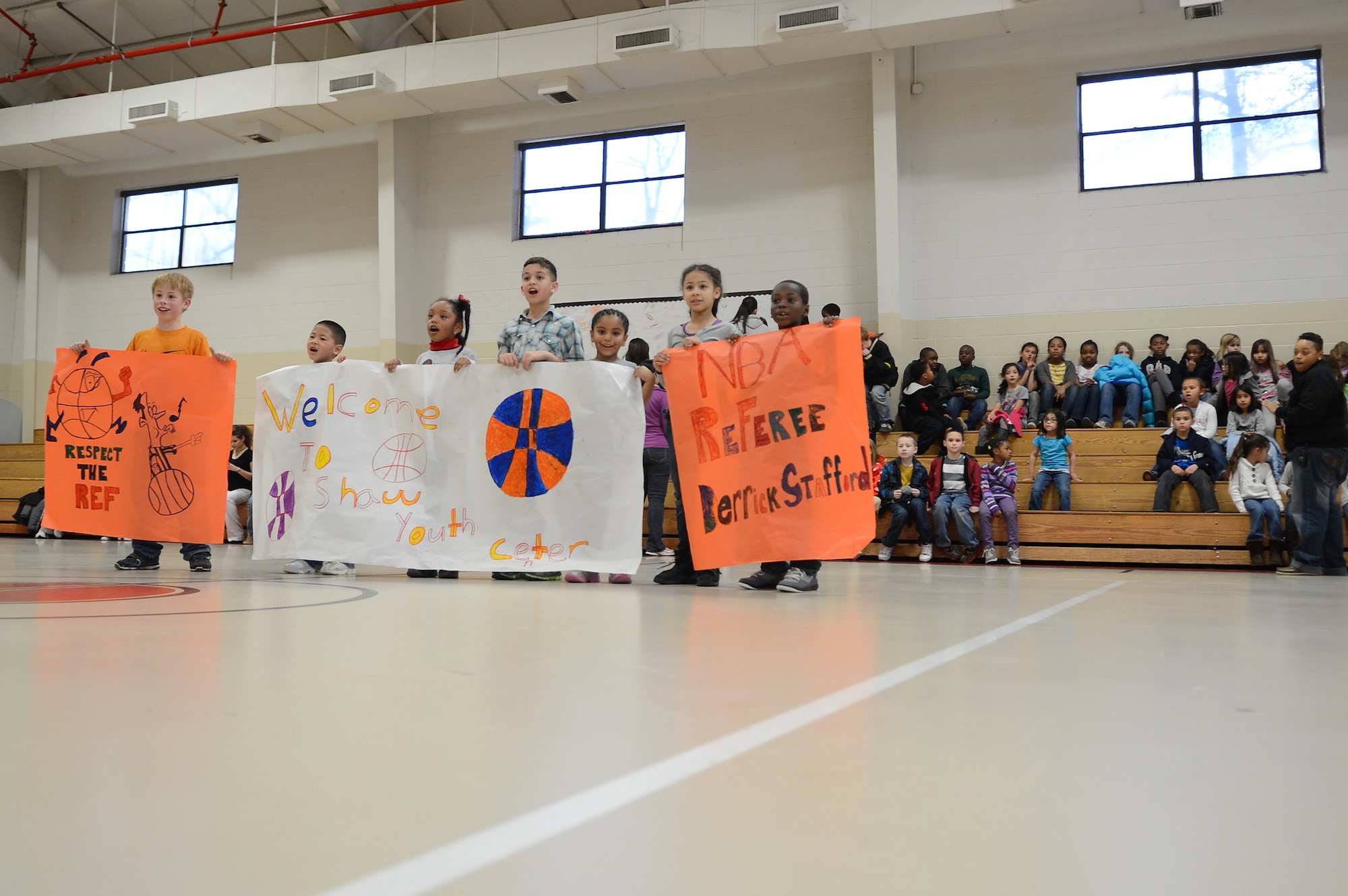 Kids hold up signs to greet Derrick Stafford, National Basketball Association referee, at the Shaw Air Force Base youth center, S.C., Dec. 14, 2012.  Stafford is in his 25th NBA season and has served twice on the executive board of the NBA Referee Association.  (U.S. Air Force photo by Airman 1st Class Nicole Sikorski/Released)
