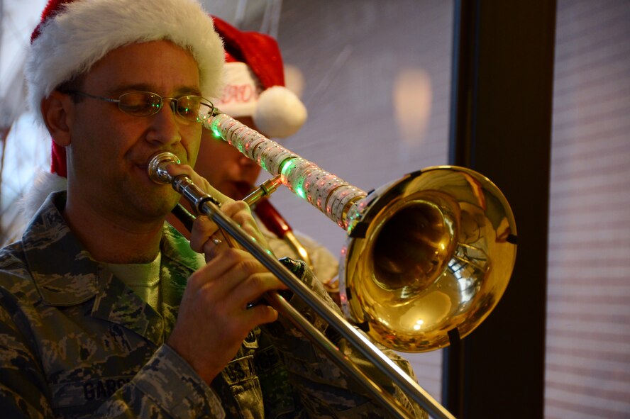 U.S. Air Force Tech. Sgt. John Garcia, Joint Base Langley-Eustis regional band craftsman, plays the banjo during a performance for people at the pharmacy in the medical group, Shaw Air Force Base, S.C., Dec. 12, 2012. The jazz ensemble caroled at the most popular buildings around Shaw spreading holiday cheer. (U.S. Air Force photo by Senior Airman Tabatha Zarrella/Released)