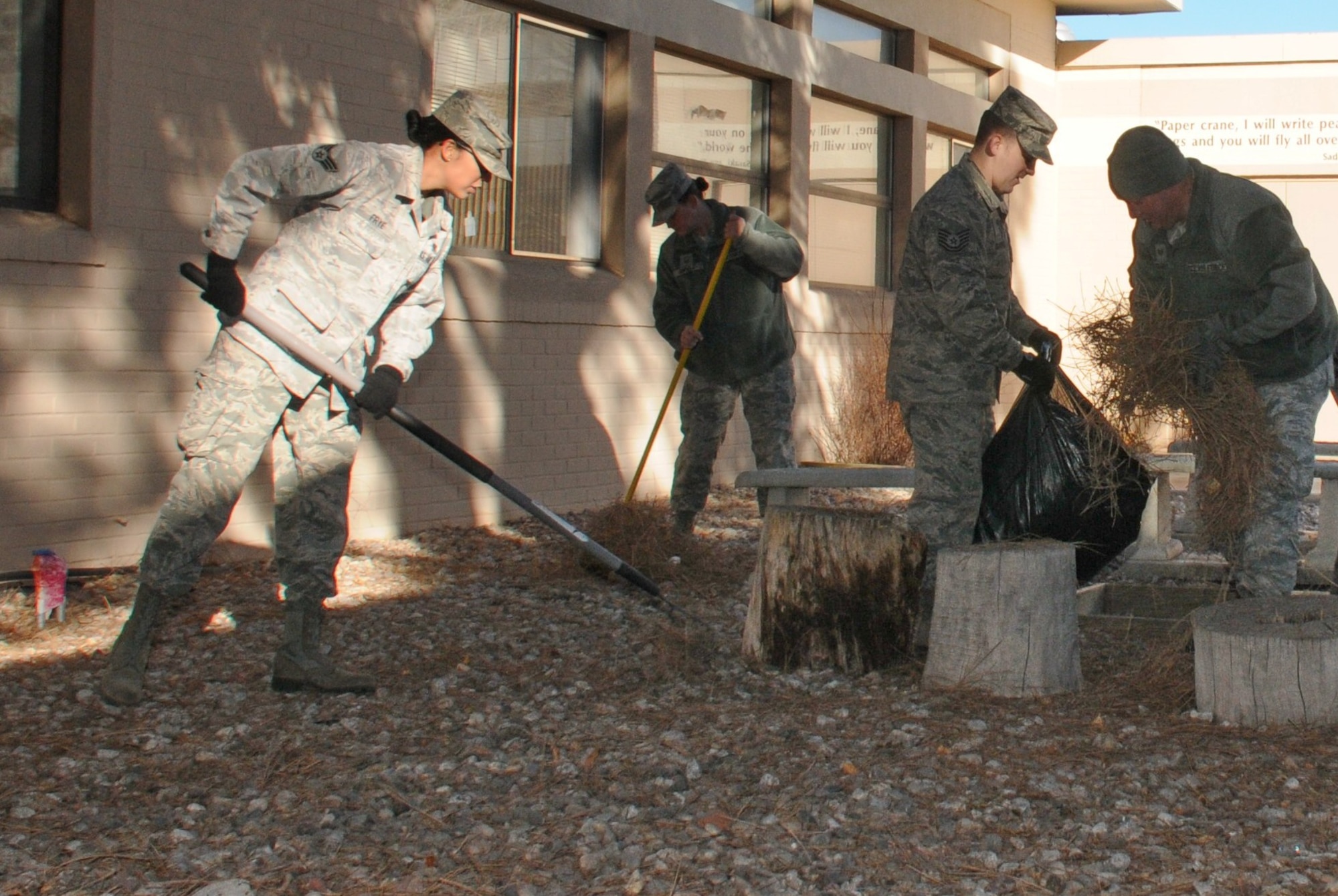 KIRTLAND AFB, N.M. – As part of Wingman Day 2012, volunteers from here cleaned the grounds of Sandia Base Elementary School Dec. 12. (Photo by Ken Moore) 