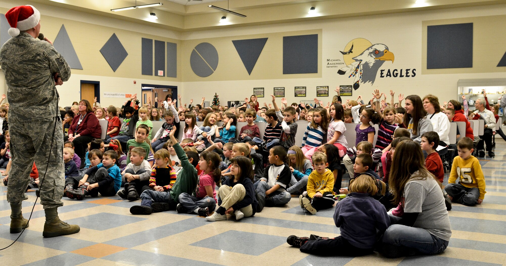 Tech. Sgt. Tom Hanrahan talks with students of Michael Anderson Elementary School about essential music facts at Fairchild Air Force Base, Wash., Dec. 14, 2012. Hanrahan is a French horn player with the Golden West Brass Quintet that visited Fairchild and the surrounding community Dec. 13 and 14, playing holiday classics such as “We wish you a Merry Christmas” and “Jingle Bell Rock.” The technical sergeant is originally from Salt Lake City. (U.S. Air Force photo by Senior Airman Benjamin Stratton)