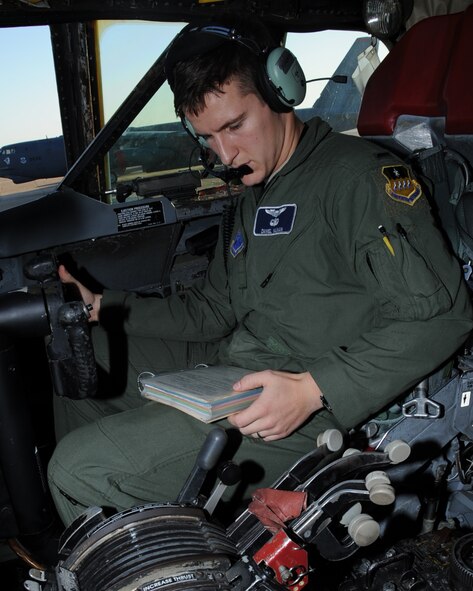 1st Lt. Daniel Nauman, 20th Bomb Squadron co-pilot, looks at an in-flight guide during a radio rodeo on Barksdale Air Force Base, La., Dec. 18. The purpose of the rodeo was to troubleshoot aircraft radios that allow aircrew to maintain better communication with ground crews. (U.S. Air Force photo/Senior Airman Sean Martin)