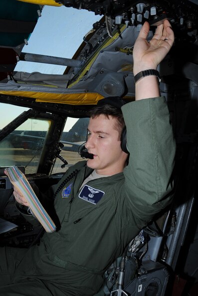 1st Lt. Daniel Nauman, 20th Bomb Squadron co-pilot, looks at an in-flight guide during a radio rodeo on Barksdale Air Force Base, La., Dec. 18. The purpose of the rodeo was to troubleshoot aircraft radios that allow aircrew to maintain better communication with ground crews. (U.S. Air Force photo/Senior Airman Sean Martin)