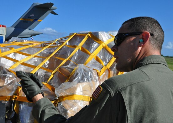 Tech. Sgt. James Fuller, 300th Airlift Squadron helps coordinate offloaded humanitarian cargo in St. Lucia this past weekend.  The 315th Airlift Wing missions involved two C-17 Globemaster III aircraft delivering humanitarian aid, medical and school supplies, food and construction equipment valued at more than $130,000. (U.S. Air Force Photo by Capt. Wayne Capps)