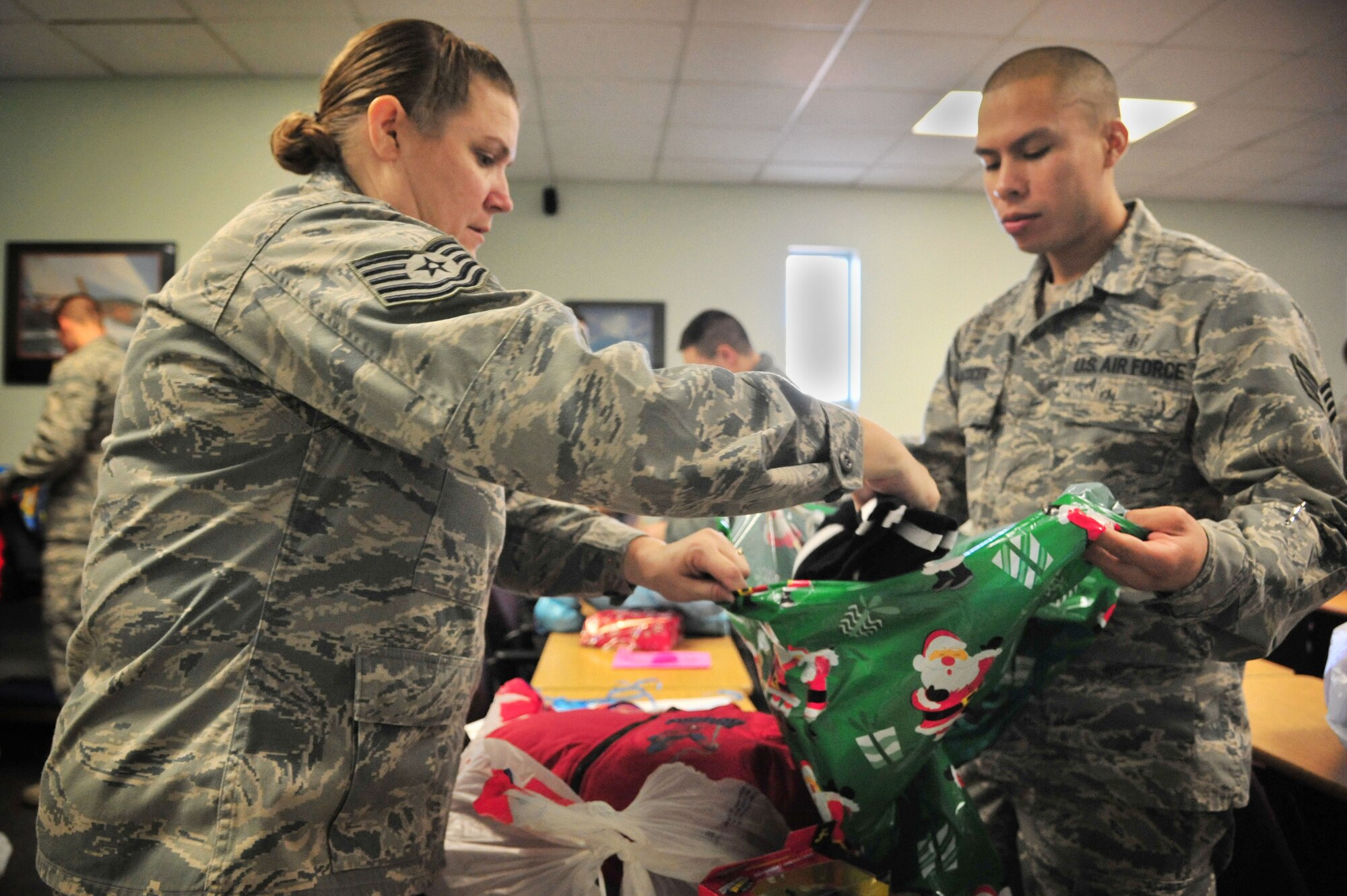 U.S. Air Force Tech. Sgt. Jillian Beausoleil, 27th Special Operations Support Squadron combat medic, works with Staff Sgt. Humberto Alcocer, 27 SOSS medic, to gather gifts donated through the Angel Tree program in the Thrift Shop at Cannon Air Force Base, N.M., Dec. 18, 2012. More than 300 gifts were provided from generous members of the wing to ensure that every child within the Cannon community has presents under their tree this year. (U.S. Air Force photo/Senior Airman Alexxis Pons Abascal) 