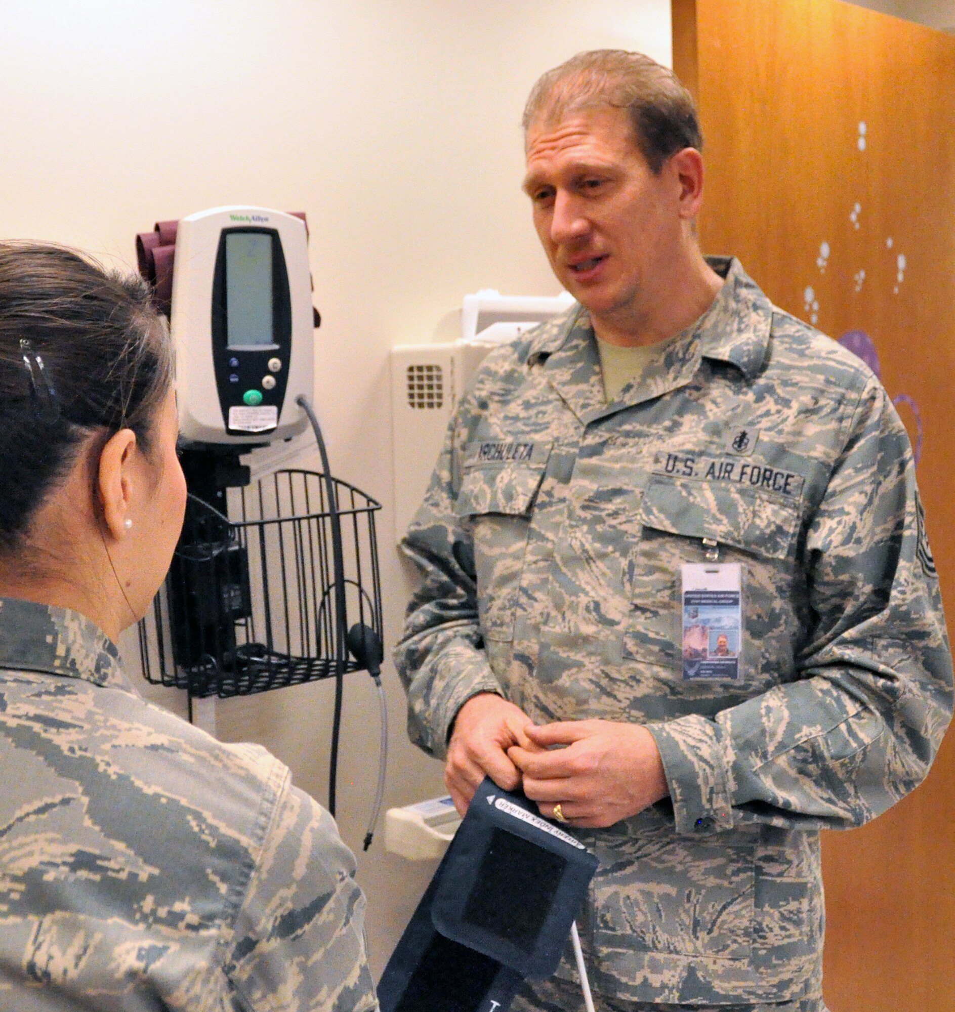 Tech. Sgt. Christopher Archuleta, an Aeromedical Service Journeyman with the 302nd Aerospace Medicine Flight reviews correct usage of blood pressure instruments with fellow medical staff Dec. 1.