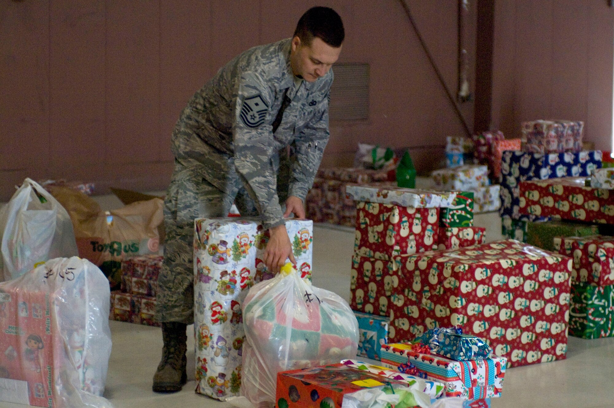 Master Sgt. Brian Noethlich,  57th Operations Group first sergeant, sorts gifts for Operation Warmheart Dec. 17, 2012 at Nellis Air Force Base, Nev.  Gifts were donated from the Nellis and Creech community to assist families that need a helping hand this holiday. (U.S. Air Force photo by Airman 1st Class Monet Villacorte)