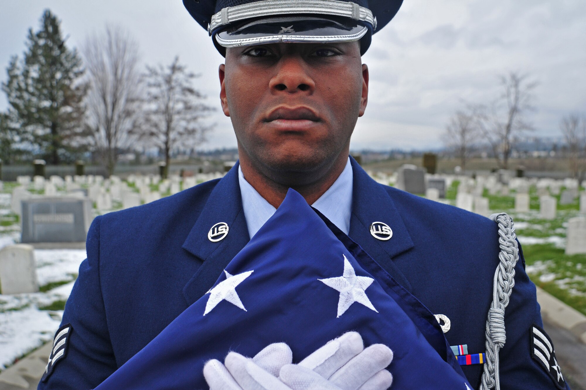 Senior Airman Eric Frederick, member of the Fairchild Honor Guard, stands by during the Wreaths Across America event at the Fort Wright Cemetery in Spokane, Wash., Dec. 15, 2012. This marks the first year that Wreaths Across America was held at the cemetery. (U.S. Air Force photo by Airman 1st Class Taylor Curry)
