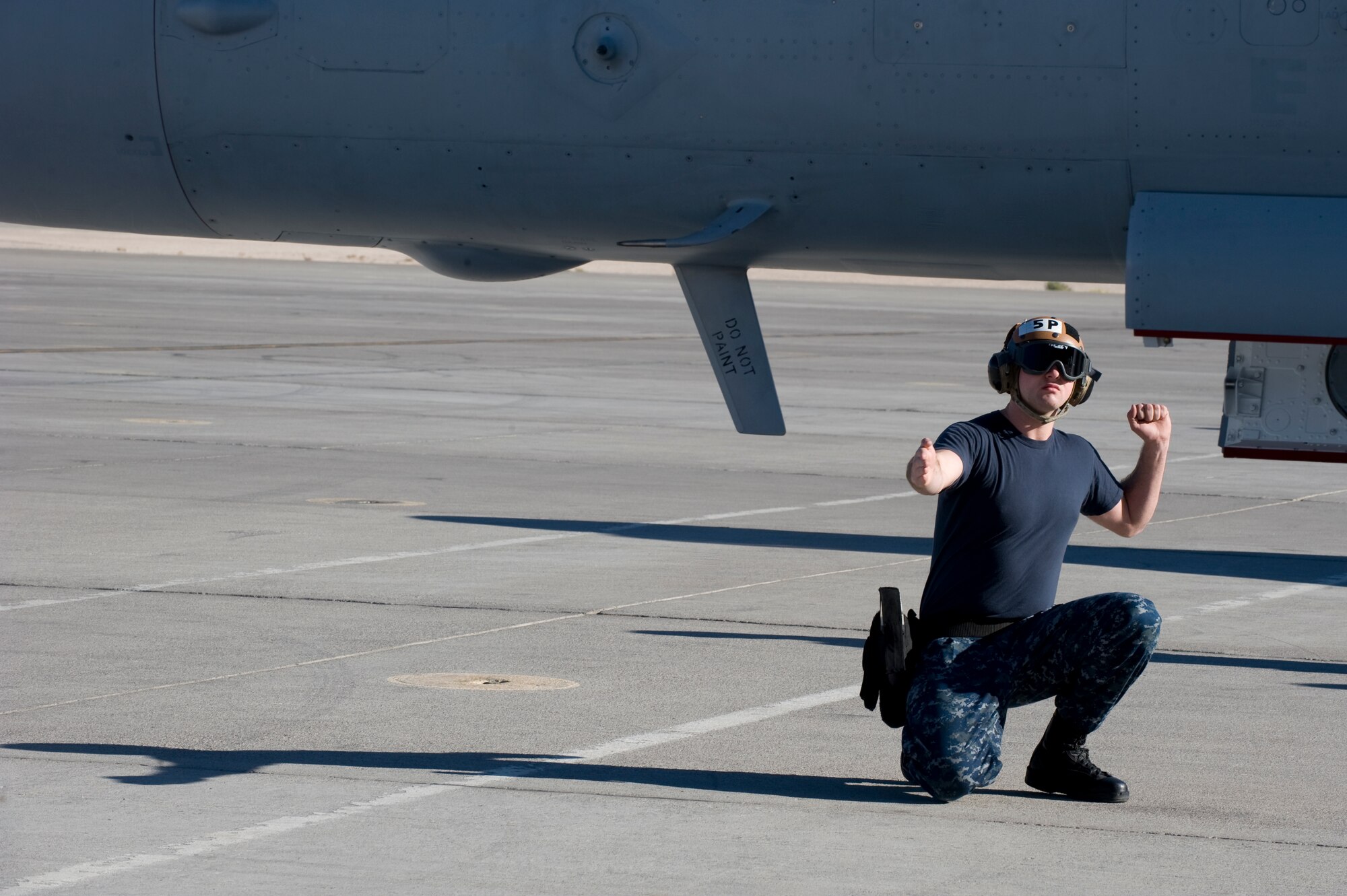 Seaman Trevor Stratton, Electronic Attack Squadron 138 plane captain, performs pre-flight checks on an EA-18G Growler during the U.S. Air Force Weapons School Mission Employment Phase Dec. 11,, 2012, at Nellis Air Force Base, Nev. The EA-18G Growler is an airborne electronic attack aircraft which operates from aircraft carriers or from land-bases. (U.S. Air Force photo by Senior Airman Matthew Lancaster)
