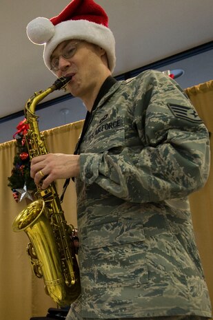Staff Sgt. Ronald Glenn, U.S. Air Force Band of the Golden West member, provides holiday music using his saxophone Dec. 14, 2012, at Nellis Air Force Base, Nev. Glenn and other band members travel during the holiday season, providing traditional holiday music classics. (U.S. Air Force photo by Airman 1st Class Christopher Tam)