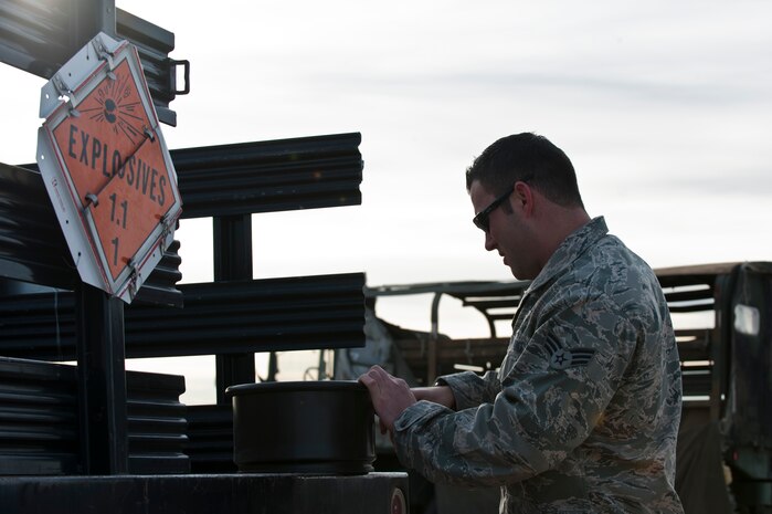 Senior Airman Luke Albrecht, 99th Civil Engineer Squadron explosive ordinance disposal journeyman, unpacks explosives for a mass odor exercise which helps train military working dogs and civilian bomb sniffing dogs Dec. 11, 2012, at Nellis Air Force Base, Nev.  It was EOD’s first time providing ordinance for the exercise at Nellis. (U.S. Air Force photo by Airman 1st Class Jason Couillard)