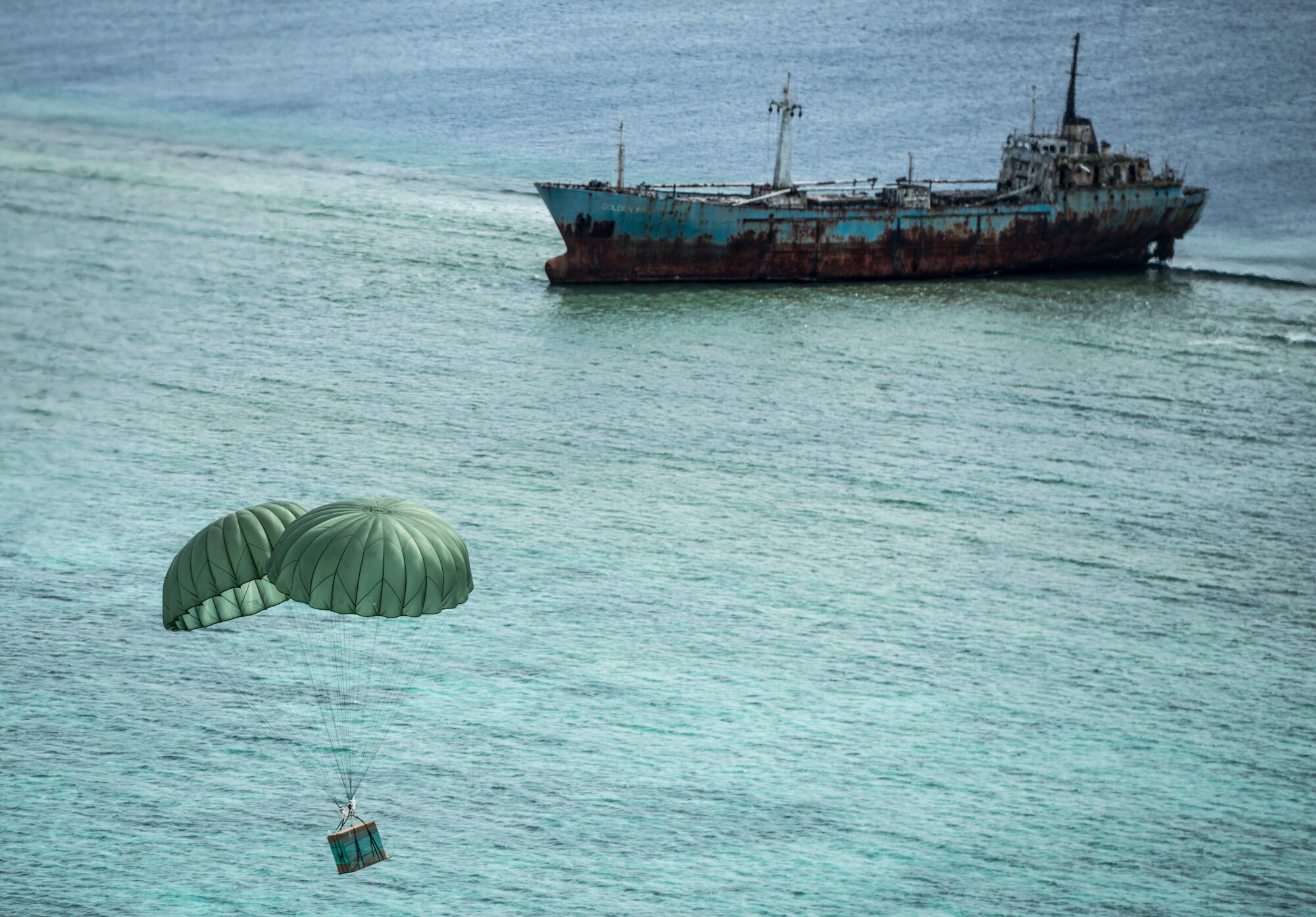 OVER THE PACIFIC OCEAN -- A bundle carrying humanitarian supplies and gifts drifts to the ground off the shore an island in Micronesia Dec. 18, 2012. C-130 Hercules crews from Yokota Air Base, Japan, flew missions out of Andersen Air Force Base, Guam, airlifting the donated bundles to islands in need as part of Operation Christmas Drop. (U.S. Air Force photo by Tech. Sgt. Samuel Morse)