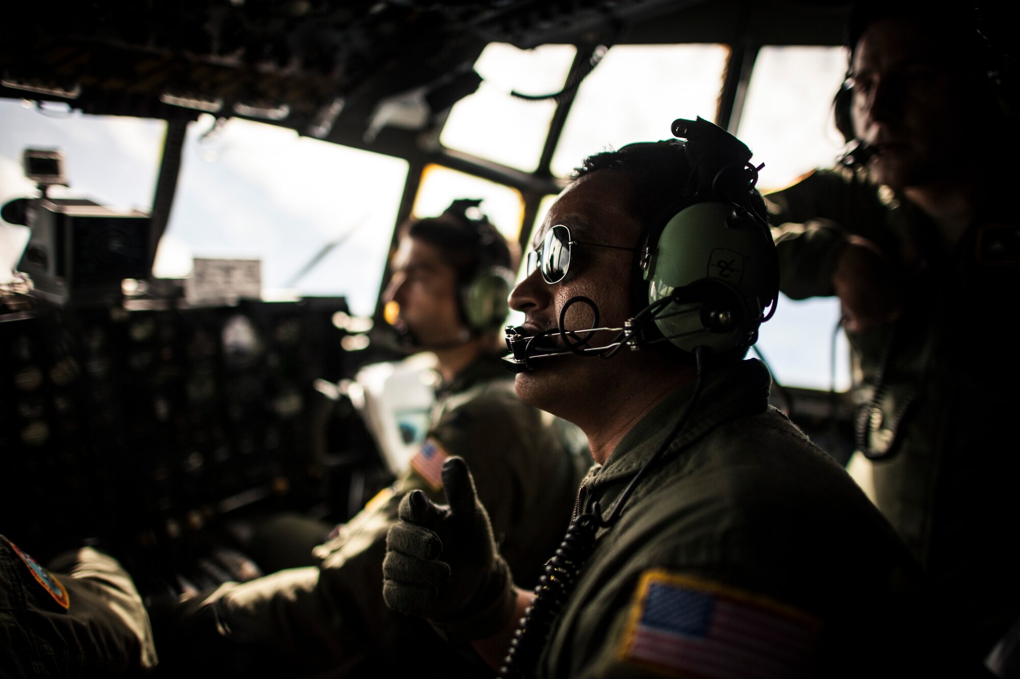 OVER THE PACIFIC OCEAN -- The crew of a C-130 Hercules from Yokota Air Base, Japan, look for markings of a drop zone on an island in Micronesia Dec. 18, 2012. The crew carried a bundle of donated supplies from Andersen Air Force Base, Guam, as part of Operation Christmas Drop. (U.S. Air Force photo by Tech. Sgt. Samuel Morse)