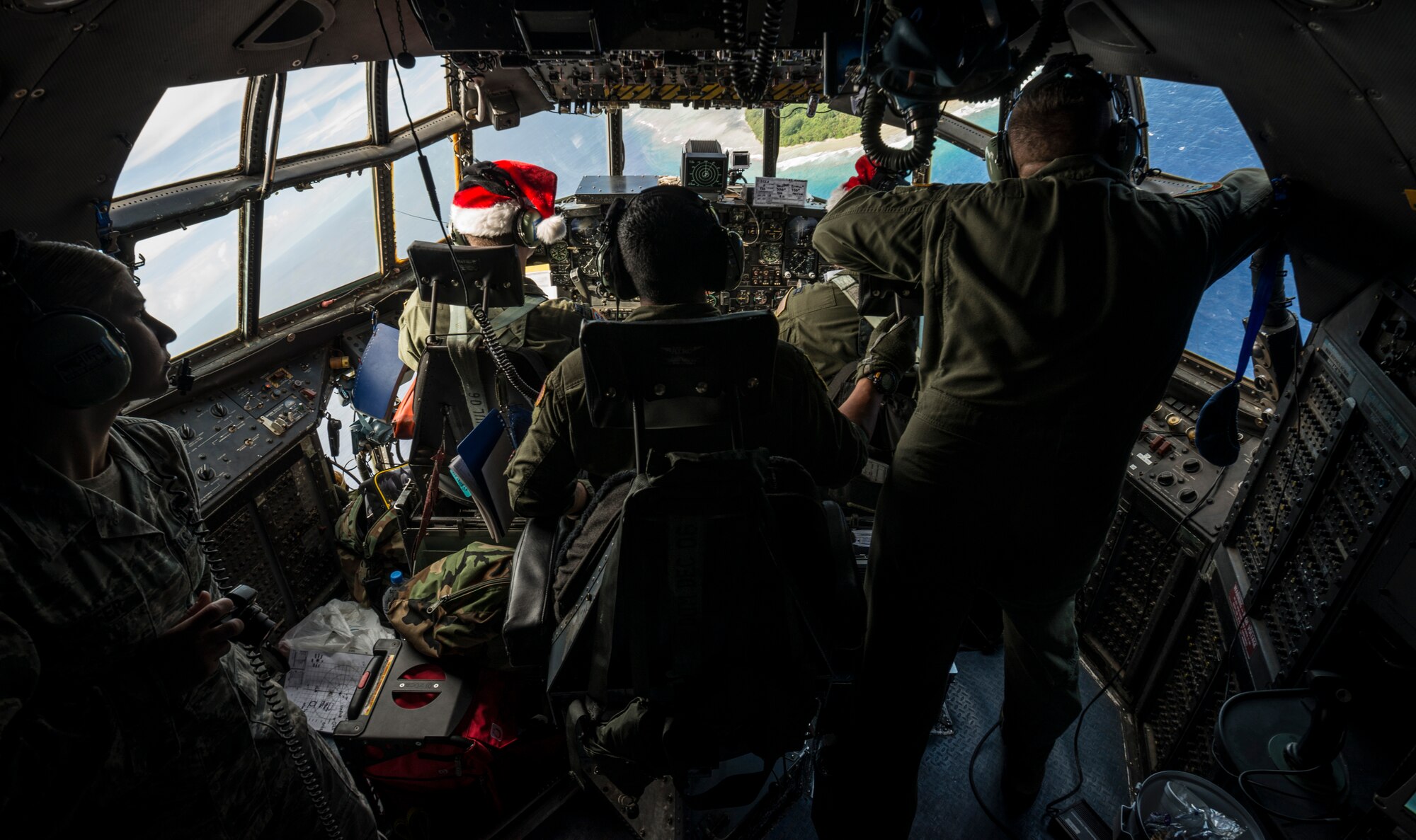 OVER THE PACIFIC OCEAN -- The crew of a C-130 Hercules from Yokota Air Base, Japan, look for markings of a drop zone on an island in Micronesia Dec. 18, 2012. The crew carried a bundle of donated supplies from Andersen Air Force Base, Guam, as part of Operation Christmas Drop. (U.S. Air Force photo by Tech. Sgt. Samuel Morse)