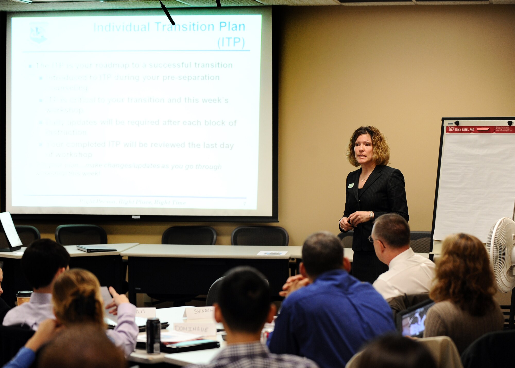 Julia Noe, a Transition Assistance Program Coordinator with the Family Readiness Center, gives opening remarks to dozens of students preparing to make the leap from active duty members to civilian life beyond the gates of a military instillation, Offutt Air Force Base, Neb., Nov. 5.  Students will relearn how to work and live in the private sector after years of military service and structure.  (U.S. Air Force photo by Josh Plueger/Released)