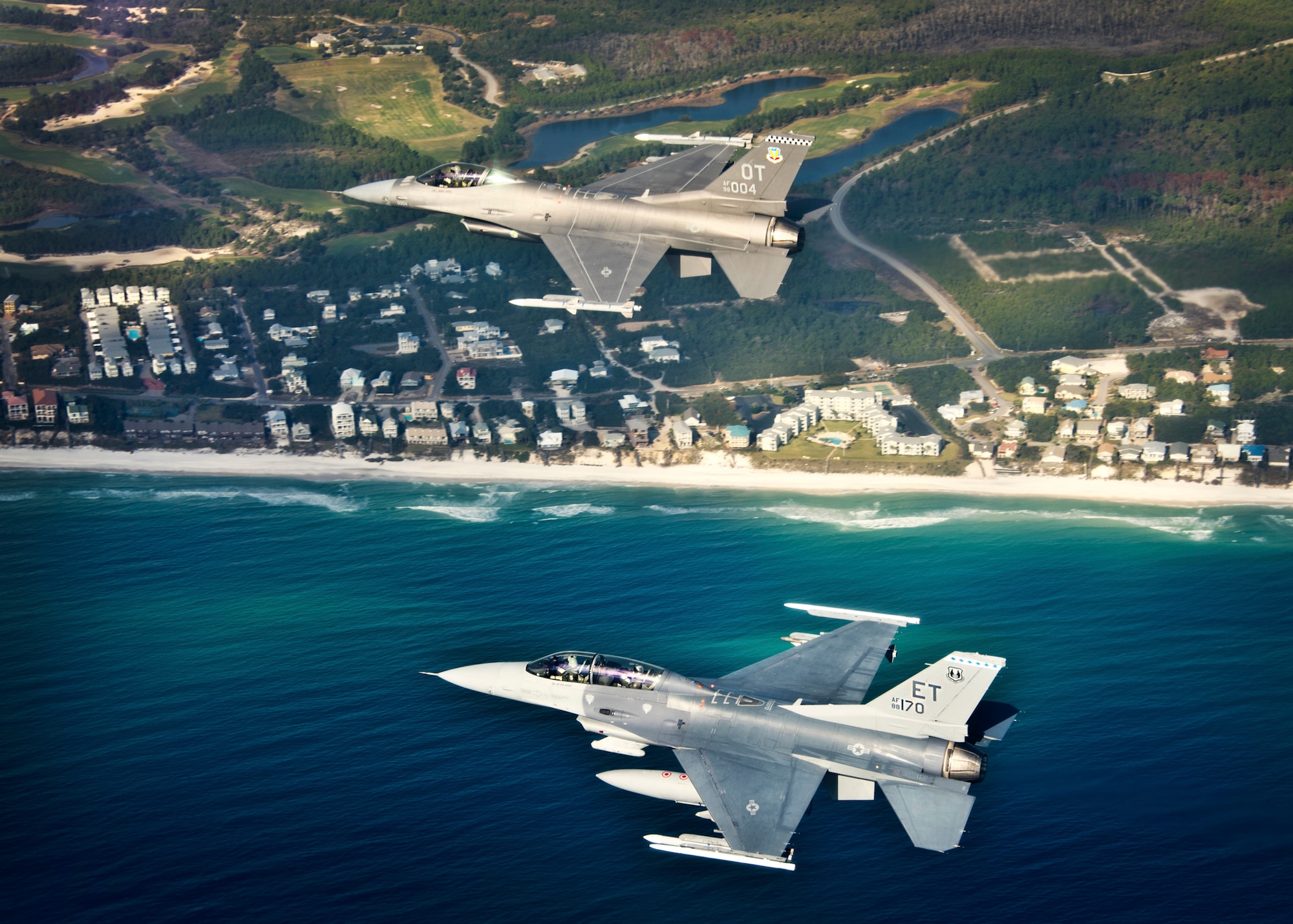 F-16 Fighting Falcons from the 40th Flight Test Squadron and 85th Test and Evaluation Squadron fly over the Emerald Coast Dec. 6 on a design-try-out mission for a new operational flight program software upgrade. The newest OFP for Block 40 and 50 model F-16s will be tested developmentally and operationally at Eglin Air Force Base, Fla., in 2014. This marks the first time ever an F-16 OFP has undergone developmental and operational testing in the same location. (Courtesy photo)
