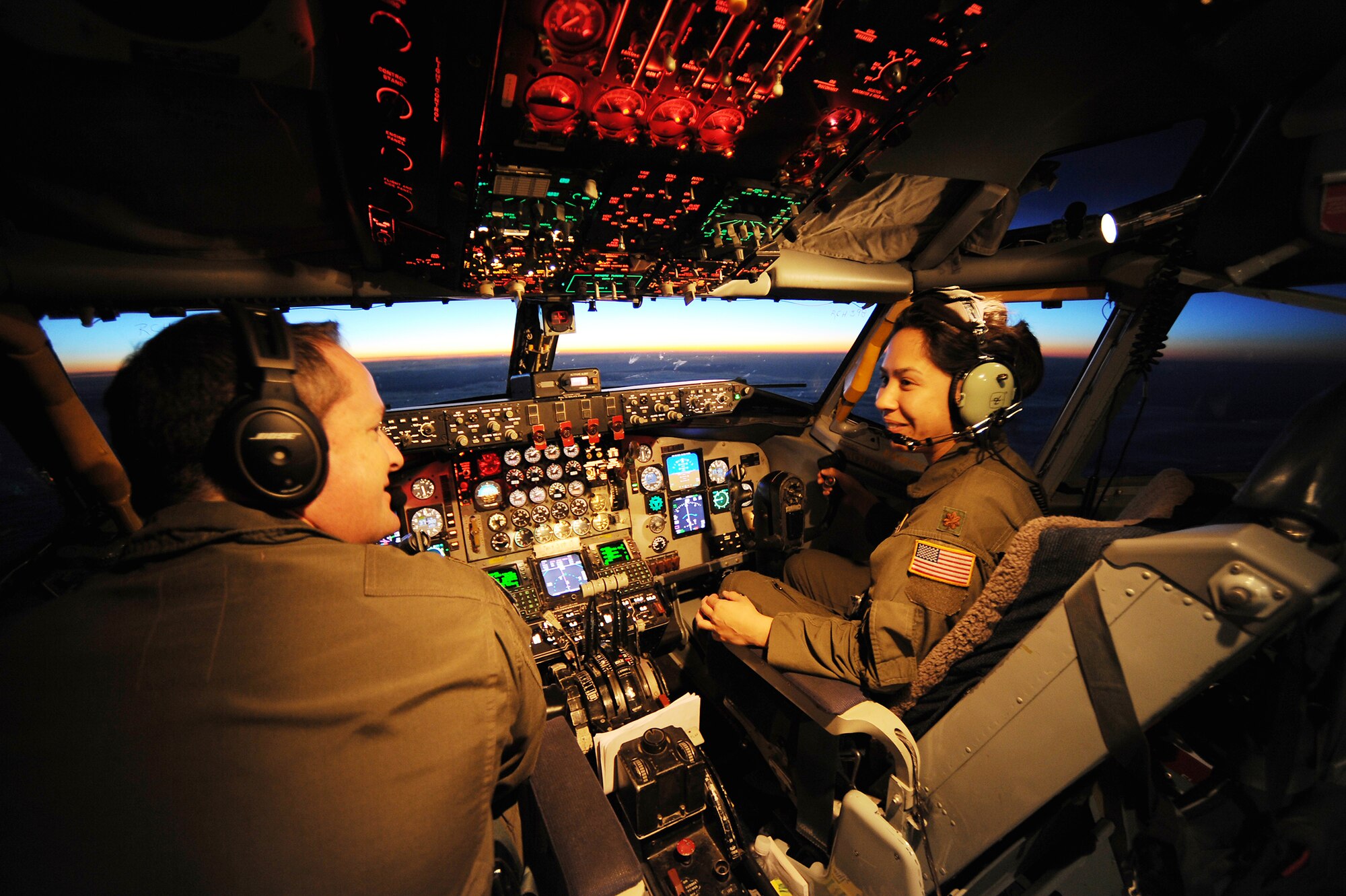 Maj. Christine Stanaback and Maj. Dean Rancourt, pilots with the 63rd Air Refueling Squadron, fly in a KC-135 during a flight over the Atlantic Ocean December 16, 2012. Stanaback and Rancourt, along with a team of Airmen from MacDill Air Force Base, Florida, flew an Air Force Reserve training mission with pallets of humanitarian cargo as part of the Denton Program, a program that allows military aircraft to transport aid supplies on a space-available basis. (U.S. Air Force photo by Staff Sgt. Jennie Chamberlin)