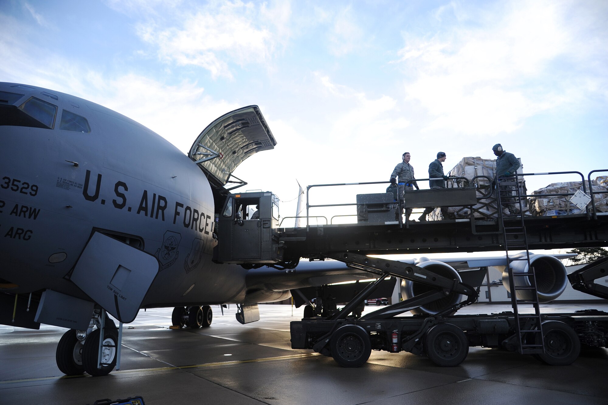 A team of Airmen from Ramstein Air Base, Germany, offload pallets of humanitarian cargo from a KC-135 at Ramstein AB, December 15, 2012. The cargo was transported by a team of Airmen from MacDill Air Force Base for an Air Force Reserve training mission as part of the Denton Program, a program that allows military aircraft to transport aid supplies on a space-available basis. (U.S. Air Force photo by Staff Sgt. Jennie Chamberlin)