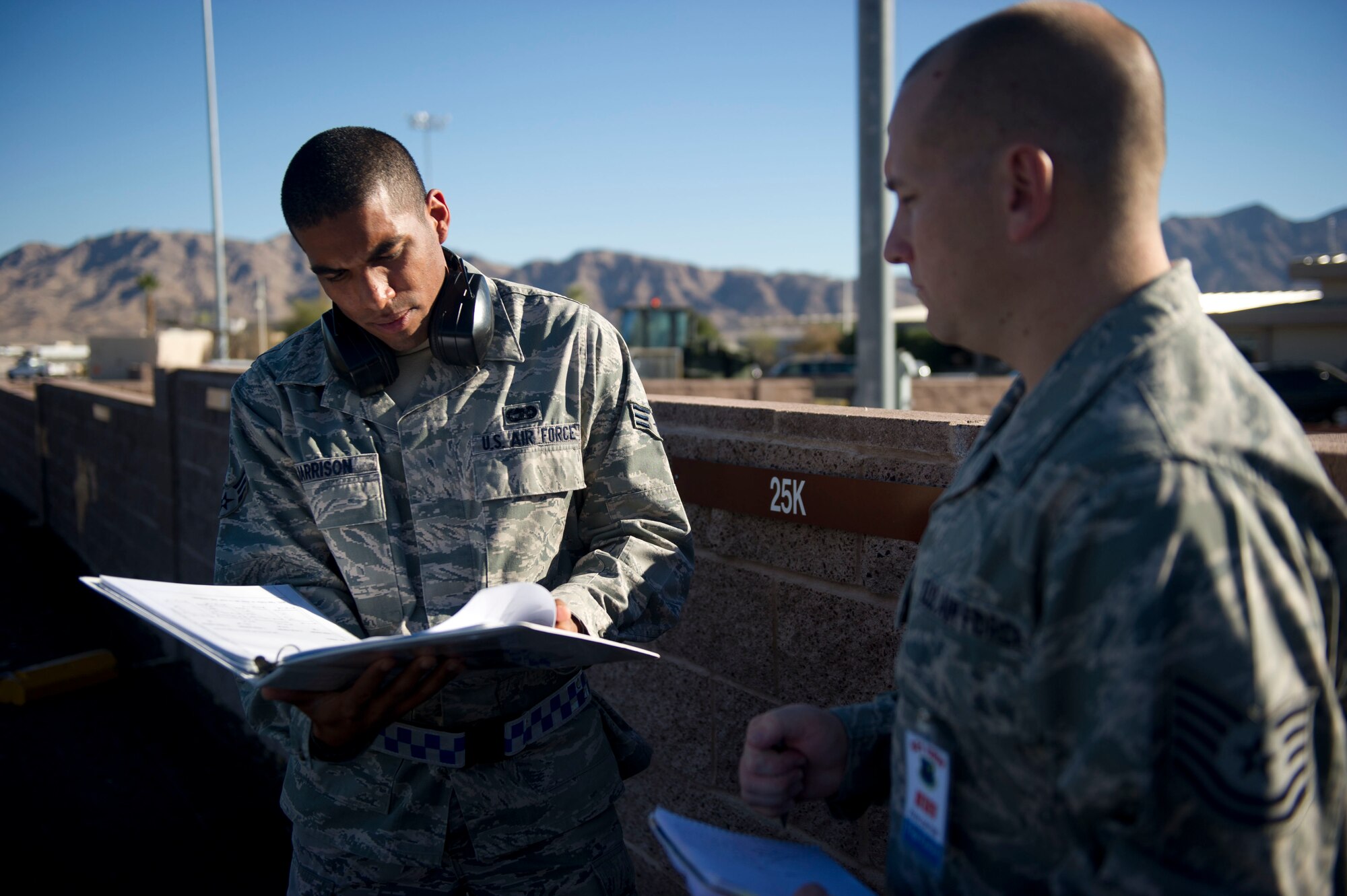 Senior Airman Cedric Harrison, 817th Global Mobility Squadron aerial port, is evaluated by Tech. Sgt. Jeffrey Fairlie, 817th GMS aerial port, during the Mission Employment phase exercise at Nellis Air Force Base, Nev. December 5, 2012. More than 60 Airmen from the 621st Contingency Response Wing got a chance to hone their skills and help train Weapons School students. (U.S. Air Force photo by Staff Sgt. Gustavo Gonzalez)