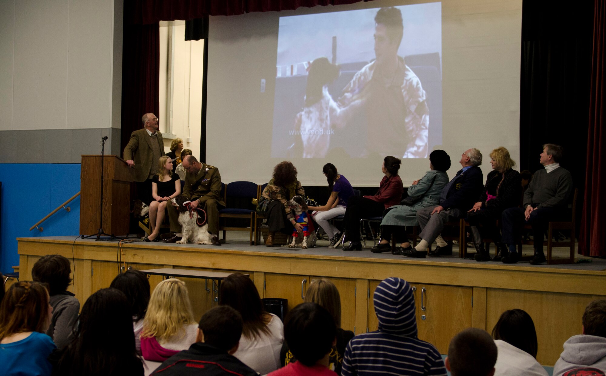 ROYAL AIR FORCE FELTWELL, England - Lakenheath Middle School students watch a video featuring British Army Lance Corporal James Wilkinson, Royal Army Veterinary Corps military working dog handler, and Jaimie, an English Springer Spaniel and Royal Army Veterinary Corps vehicle search dog, during a post Remembrance Day ceremony Dec. 14, 2012. Wilkinson was injured by a road side bomb in Afghanistan on his last tour. Jamie, now retired and residing with Wilkinson's parents, served in the Royal Army Veterinary Corps most of his life and has done tours in Iraq, Kosovo, Northern Ireland and Afghanistan. (U.S. Air Force photo by Staff Sgt. Stephen Linch)