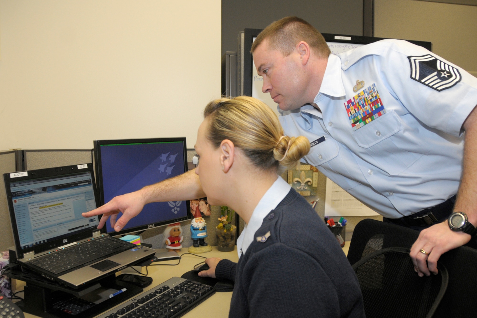 Senior Master Sgt. Russ Childs, superintendent of the 127th Comptroller Flight, points to a link of the Air Force Portal web site while working with Airman 1st Class Jennifer Lewis at Selfridge Air National Guard Base, Mich., Dec. 10, 2012. Childs is one of many Airmen at Selfridge who have taken advantage of the various educational benefits available through the military. Childs said his bachelor’s degree in business management helped prepare him for his current assignment. (Air National Guard photo by Brittani Baisden)
