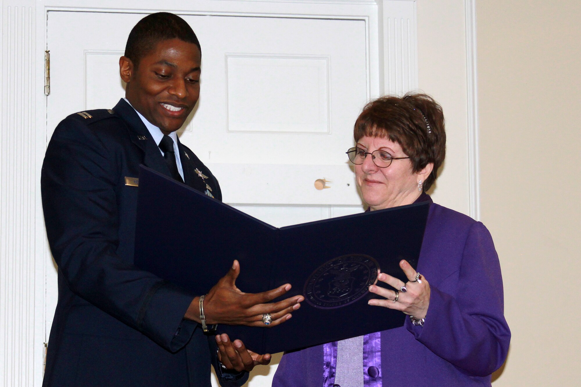 Mary Huff, 20th Communications Squadron base records manager, (right) accepts her retirement certificate during her retirement ceremony, Dec 14, 2012, Shaw Air Force Base, S.C. Huff retired after 34 years of service to the U.S. Air Force.  Her retirement ceremony was held at the Carolina Skies Club and Conference Center where several joined to celebrate and thank her for her faithful service and hard work over the years. (curtsey photo)