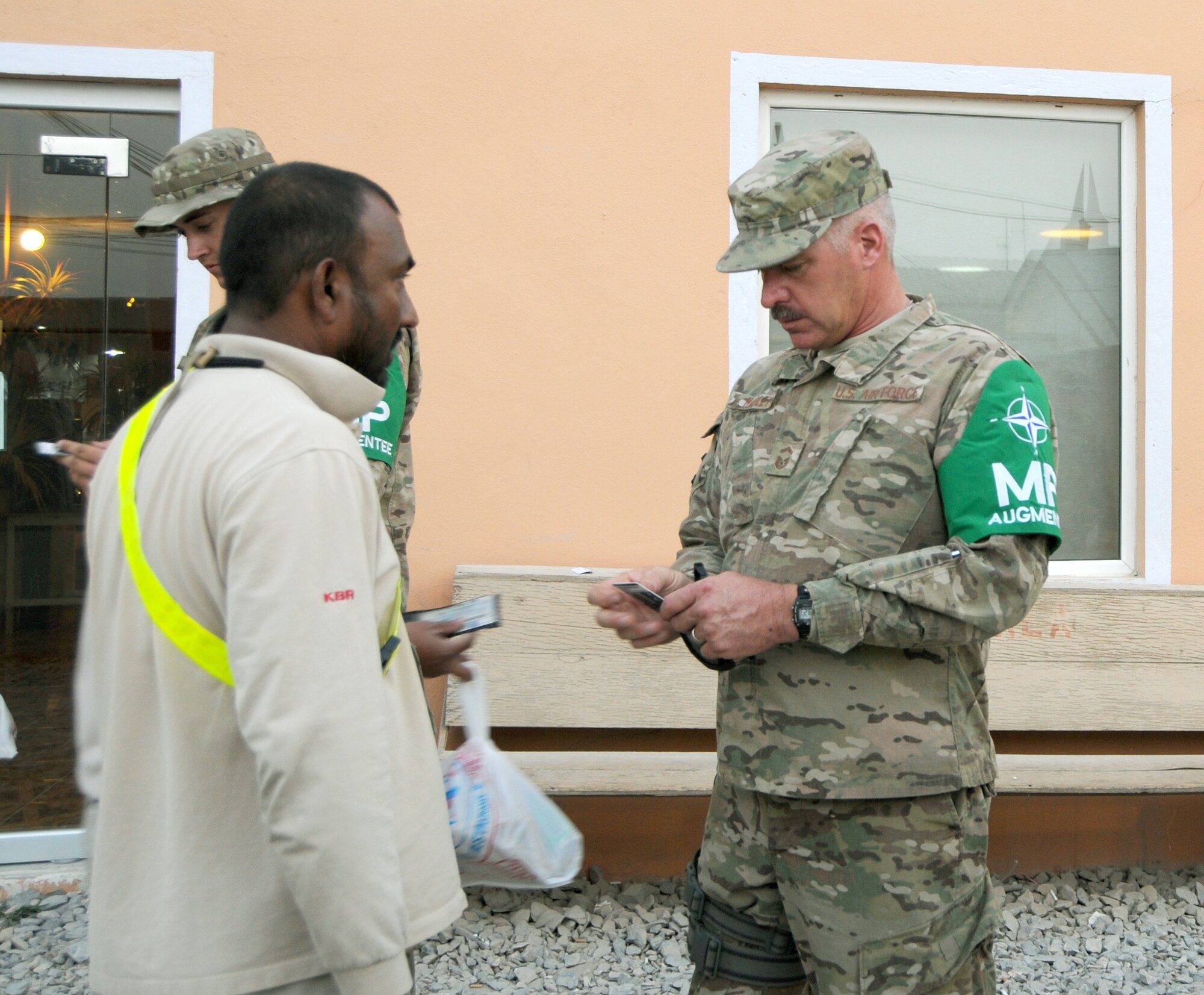 SOUTHWEST ASIA – Senior Master Sgt. Steven Hadley inspects the identification of a civilian contractor while deployed with a unit in Southwest Asia. There, he was responsible for managing over 900 vehicles in multiple forwarding operating bases and ensuring the security of his shop.  He is currently a vehicle operations superintendent with the 927th Air Refueling Wing, stationed at MacDill Air Force Base. (Photo courtesy of Senior Master Sgt. Steven Hadley)