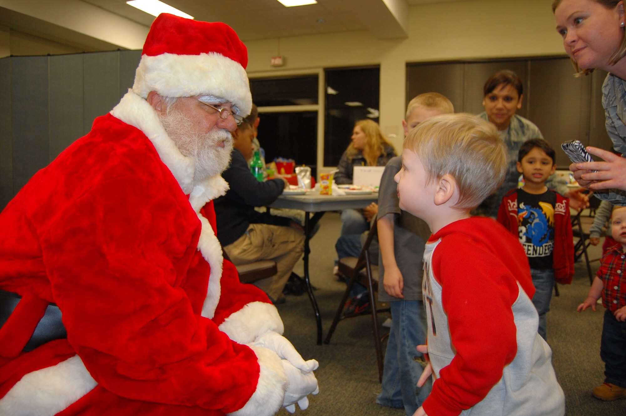 Logan Bishop talks with Santa Claus at the USAFCENT Children's
holiday party December 13 at Shaw AFB, S.C. (U.S. Air Force photo by USAFCENT Public Affairs/Released)
