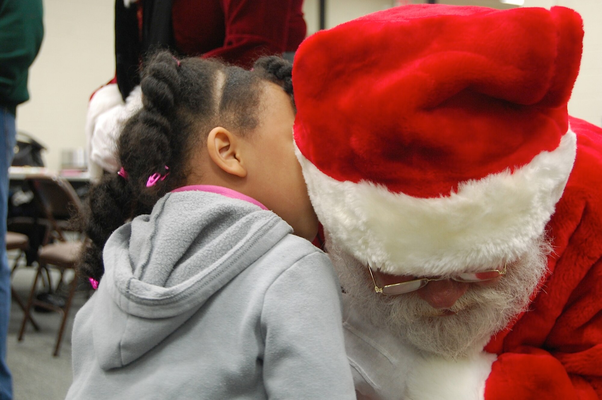 Colette Crespo whispers her Christmas wishes to Santa Claus
at the USAFCENT Children's holiday party December 13 at Shaw AFB, S.C. (U.S. Air Force photo by USAFCENT Public Affairs/Released)

