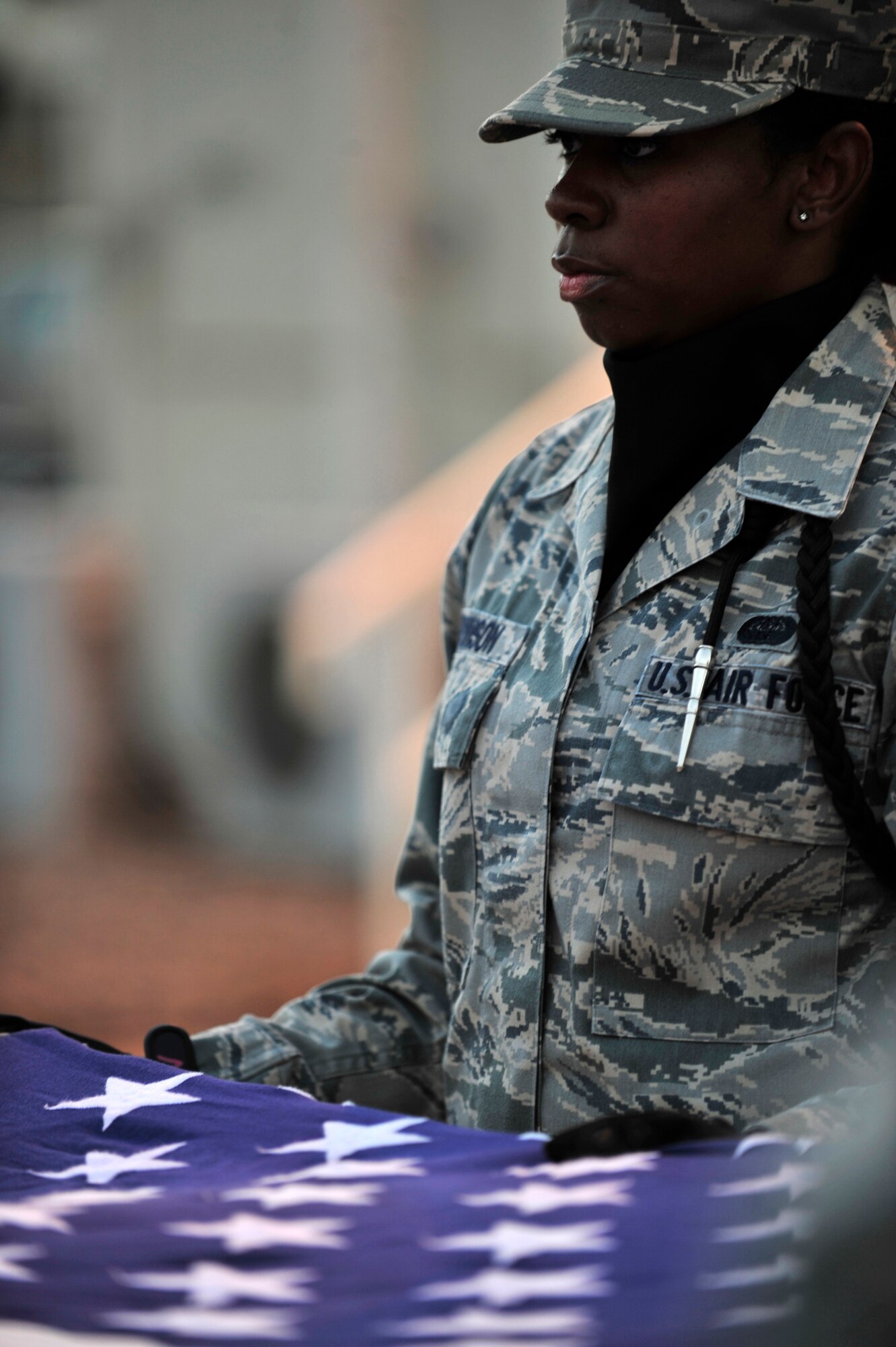 SOUTHWEST ASIA -- U.S. Air Force Airman 1st Class Jacqueline Swinson, 380th Expeditionary Security Forces Squadron member, secures the flag as it is being folded during a monthly retreat ceremony Nov. 30, 2012. The 380th AEW base honor guard is comprised of members from across the base who dedicate up to an additional four hours of their free time to bi-weekly practices and base details. (U.S. Air Force photo/Tech. Sgt. Christina M. Styer) (RELEASED)