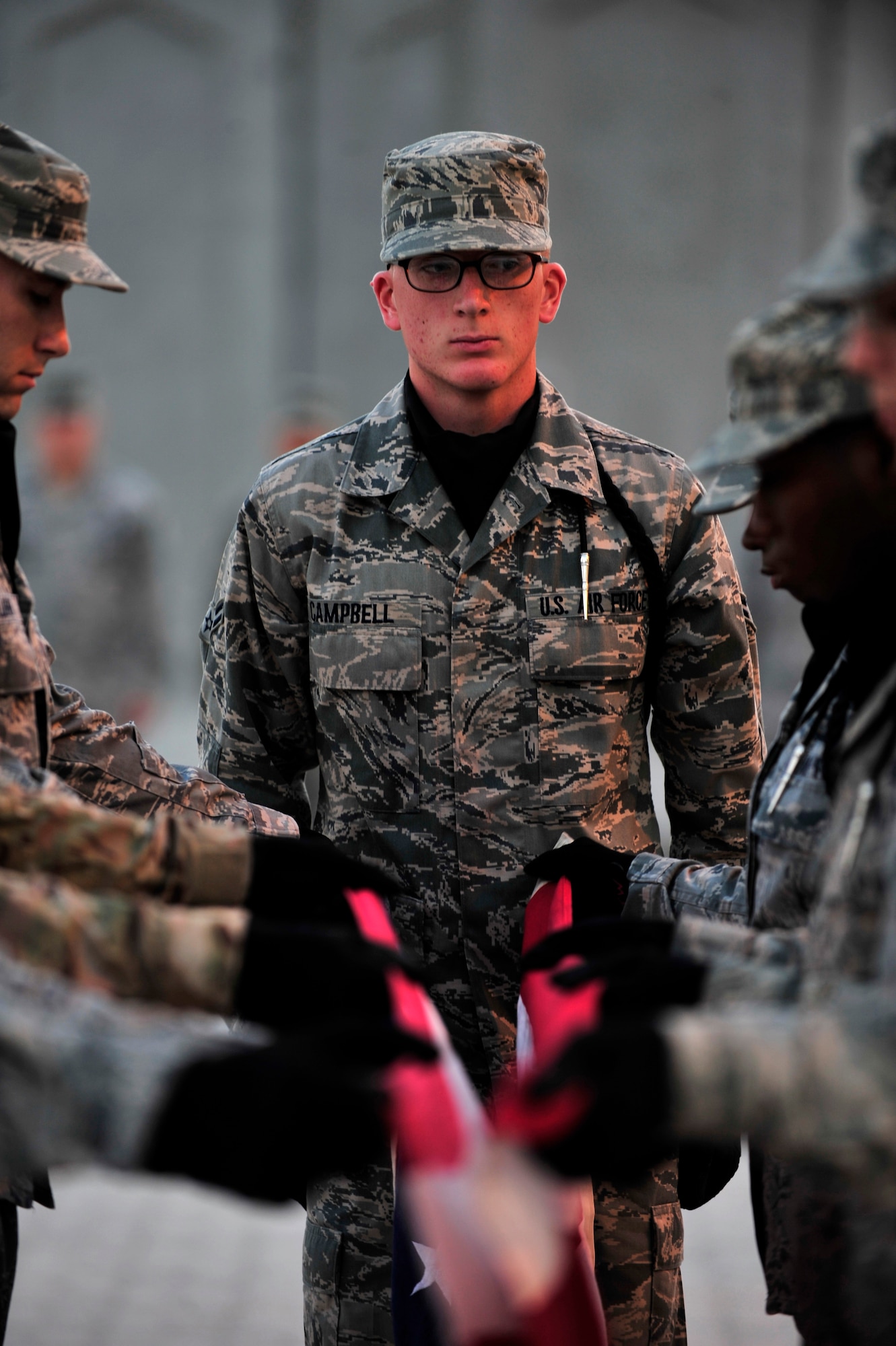 SOUTHWEST ASIA -- U.S. Air Force Airman 1st Class Phillip Campbell, 380th Air Expeditionary Wing honor guard member, performs retreat Nov. 30, 2012. In addition to their regular 12-hour, six-day-a-week work schedule, base honor guard members voluntarily devote more than fours a week to practice and details.(U.S. Air Force photo/Tech. Sgt. Christina M. Styer) (RELEASED)