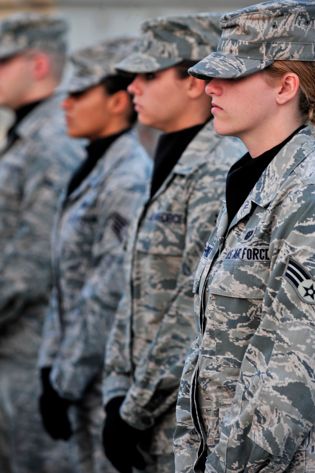 SOUTHWEST ASIA -- U.S. Air Force Senior Airman Barbra Conner-Pike, Airman 1st Class Alexandra Butler and Staff Sgt. Lisseth Silva, 380th Air Expeditionary Wing honor guard members, stand ready for the monthly retreat ceremony Nov. 30, 2012. Honor Guard members are comprised of Airmen of all ranks from across the wing who volunteer to give up their free time to perform various details and training. (U.S. Air Force photo/Tech. Sgt. Christina M. Styer) (RELEASED)