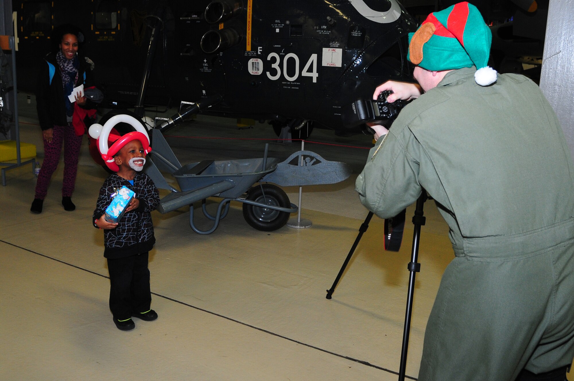 DUXFORD IMPERIAL WAR MUSEUM, England –Jamari Hargrave, 6, gets his photo taken by Maj. Bill Johnson, 492nd Fighter Squadron pilot, during a children’s Christmas party at the Duxford Imperial War Museum Dec. 15, 2012. The 492nd Fighter Squadron hosted this year’s annual children’s Christmas party, which was attended by more than 40 children including many from U.K. hospitals. (U.S. Air Force photo by Airman 1st Class Cory D. Payne)