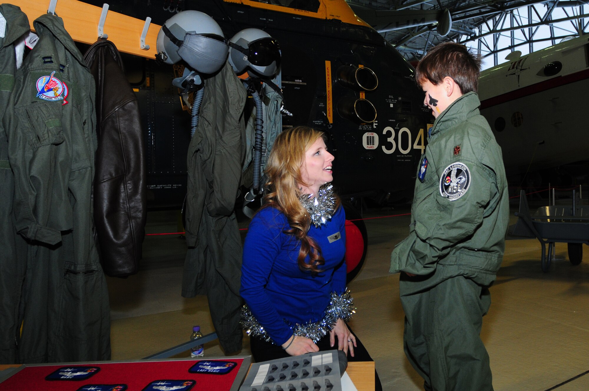 DUXFORD IMPERIAL WAR MUSEUM, England – Ashlea Johnson (left) checks over 8-year-old Samuel Hori’s flight suit before a family photo during a children’s Christmas party at the Duxford Imperial War Museum Dec. 15, 2012. The 492nd Fighter Squadron hosted this year’s annual children’s Christmas party which was attended by more than 40 children including many from U.K. hospitals. (U.S. Air Force photo by Airman 1st Class Cory D. Payne)