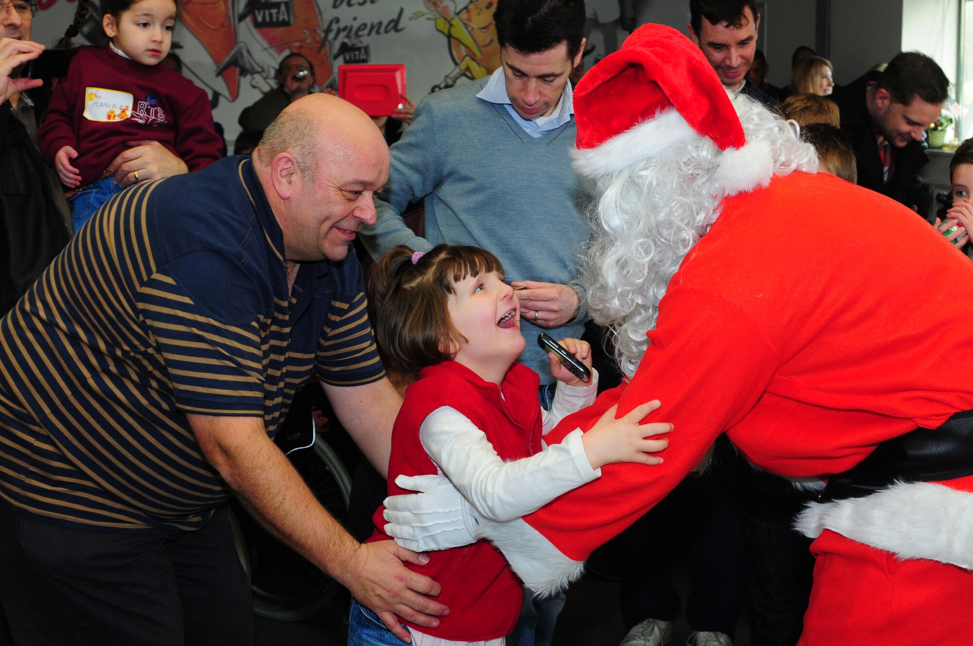 DUXFORD IMPERIAL WAR MUSEUM, England – Oliver Graham and his daughter Lizzy, 7, rush to meet Santa Claus during a children’s Christmas party at the Duxford Imperial War Museum Dec. 15, 2012. The 492nd Fighter Squadron hosted this year’s annual children’s Christmas party, which was attended by more than 40 children including many from U.K. hospitals. (U.S. Air Force photo by Airman 1st Class Cory D. Payne)