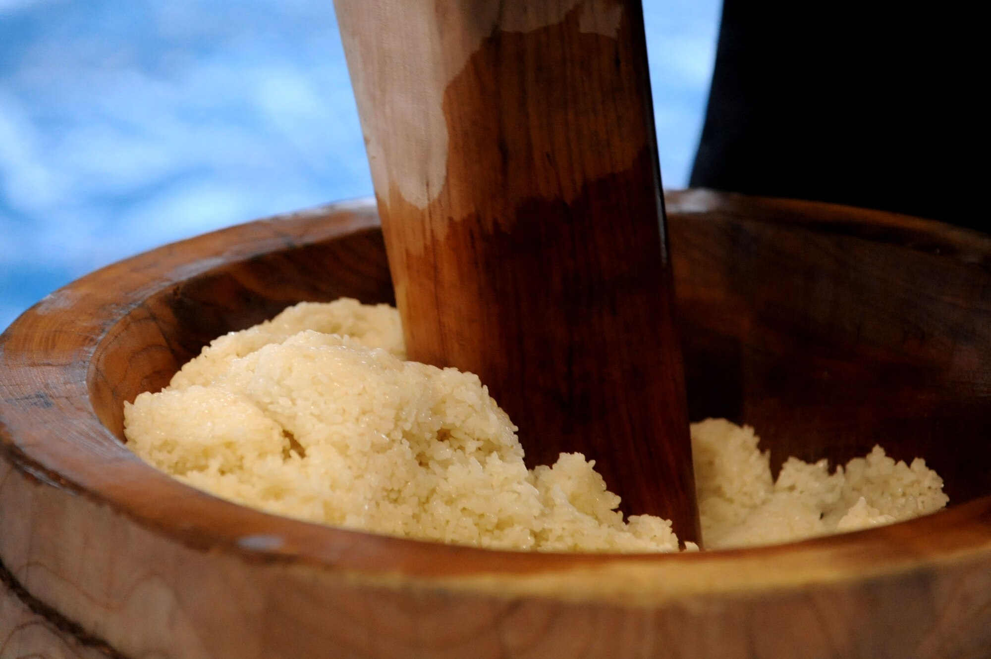 A Japanese ceremony worker pounds steamed rice during the annual mochi-pounding ceremony in the Japan Air Self-Defense Force gym at Misawa Air Base, Japan, Dec. 14, 2012. Although mochi-tsuki is eaten year-round, it is a Japanese tradition to eat it New Years Day because of it is believed to bring protection from disasters in the year to come. (U.S. Air Force photo by Airman 1st Class Kenna Jackson)