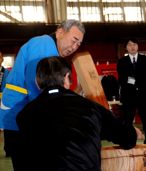 Misawa City Mayor Kazumasa Taneichi swings a wooden mallet to pound mochi during a mochi making ceremony at the Japan Air Self-Defense Force gym at Misawa Air Base, Japan, Dec. 14, 2012. Mochi is commonly eaten around the New Year because it is believed to prevent disaster in the upcoming year. (U.S. Air Force photo/Airman 1st Class Kenna Jackson) 
