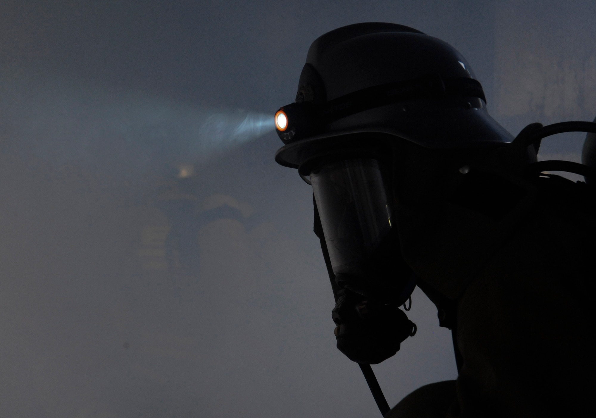 A Nirai Fire Department firefighter clears smoke from a room during mutual aid live fire training on Kadena Air Base, Japan, Dec. 17, 2012. Approximately 23 local-student firefighters used tactics and procedures they were taught to effectively extinguish a fire and rescue a victim. The live fire training is also a part of their mandatory annual training. (U.S. Air Force photo/Airman 1st Class Malia Jenkins)