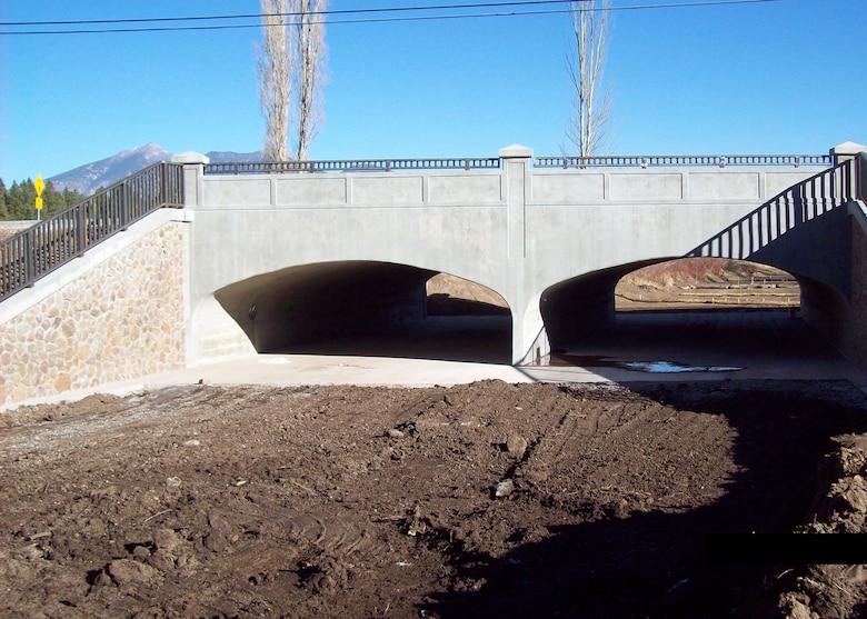 FLAGSTAFF, Ariz. -- The U.S. Army Corps of Engineers Los Angeles District completed construction on a new bridge across Thorpe Rd which more than triples the flow capacity in the area. The "classic-looking" bridge project also contains retaining walls and the wing walls with a malapai rock veneer to provide aesthetic enhancement to the flood risk management project. 