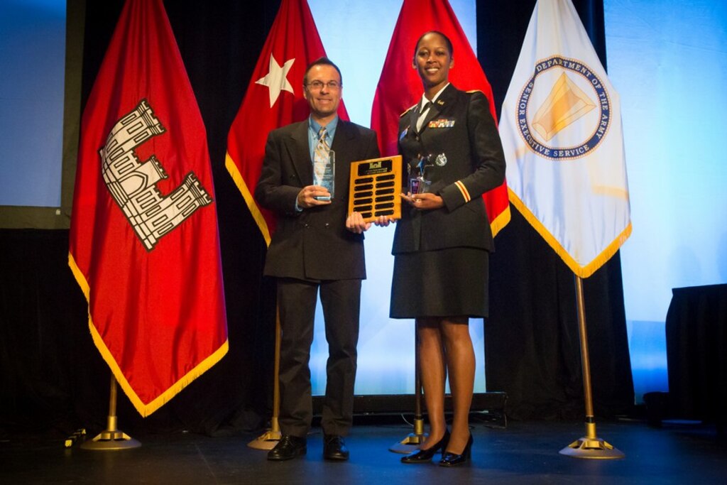GRAPEVINE, TEXAS, -- Albuquerque District Commander Lt. Col. Antoinette Gant and Deputy for Small Business Programs Daniel Curado show the three awards the District received at the Society of American Military Engineers Annual Small Business Conference Dec. 12, 2012.  The District received the Special Small Business Champion of the Year Award, Historically Black College or University/Minority Institution (HBCU/MI)Star Award, and Top 10 Service Disabled Veteran-Owned Small Businesses percentage.
