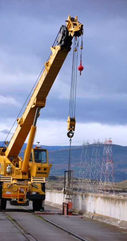 Corps of Engineers and Wash. Department of Fish and Wildlife employes dewater The Dalles Dam fish ladder. If large sturgeon are found in the fish ladder, employees will use a crane to lift the fish out of the ladder and place it back into the river.