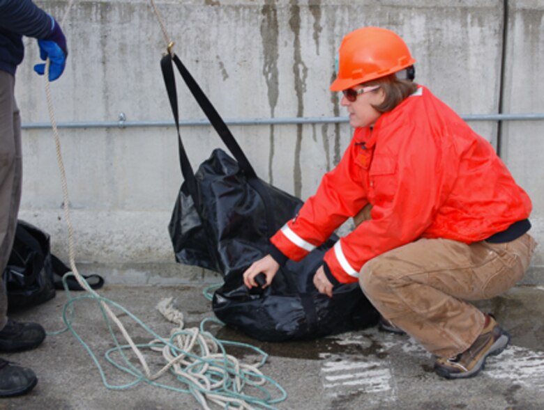 Corps of Engineers and Wash. Department of Fish and Wildlife employes dewater The Dalles Dam fish ladder.