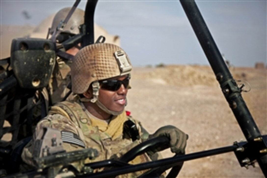 A coalition force member drives a light tactical, all-terrain vehicle during a patrol of Afghanistan's Farah province, Dec. 15, 2012.