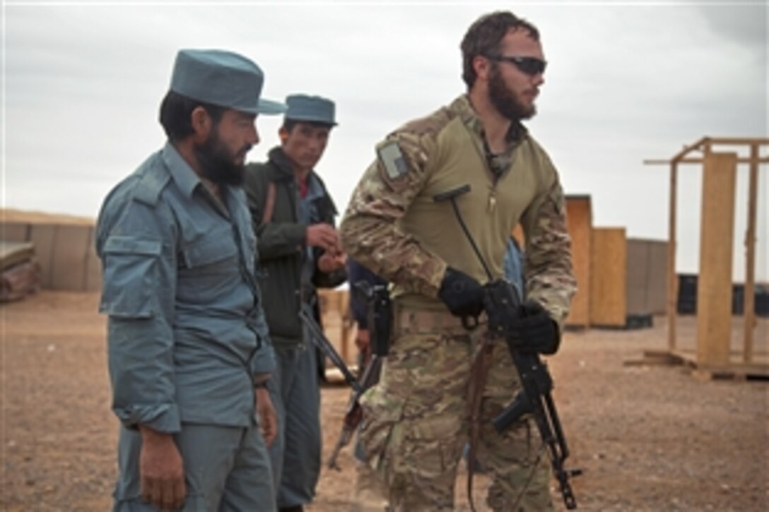 A coalition force member demonstrates weapons tactics to Afghan national police during weapons training in western Afghanistan's Farah province, Dec. 12, 2012. 
