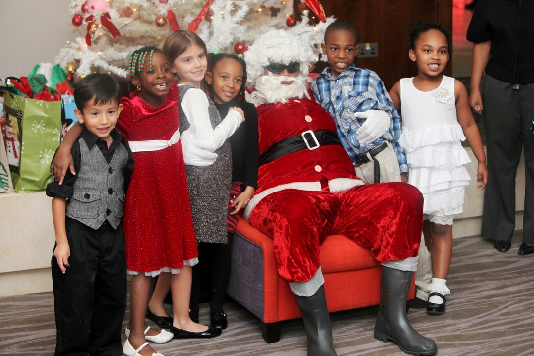 Children pose with Santa at Marine Corps Forces Central Command 2012 Holiday Party in the Kingdom of Bahrain, Dec. 13.