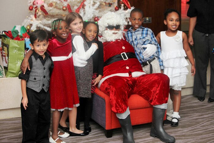 Children pose with Santa at Marine Corps Forces Central Command 2012 Holiday Party in the Kingdom of Bahrain, Dec. 13.