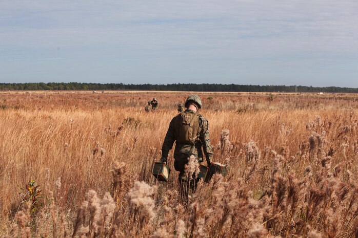 An ammunition technician with Ammunition Company, 2nd Supply Battalion, 2nd Marine Logistics Group carries two ammunition cans filled with obsolete ordnance destined for demolition aboard Camp Lejeune, N.C., Dec. 4, 2012. Thirty-one Marines from the company joined with explosive ordnance disposal technicians to conduct the demolition, which was a rare opportunity for the company’s Marines.