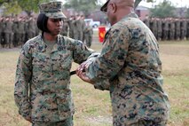 Sgt. Maj. Lanette N. Wright (left), the incoming sergeant major of Combat Logistics Regiment 2, 2nd Marine Logistics Group, takes the Sword of Office during an appointment and relief ceremony aboard Camp Lejeune, N.C., Dec. 11, 2012.  Wright, who came to CLR-2 from Combat Logistics Regiment 27, 2nd MLG, will deploy with the unit in the beginning of 2013.  