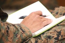 A Marine with 2nd Marine Logistics Group takes notes during an environmental awareness seminar aboard Camp Lejeune, N.C., Dec. 5, 2012. Speakers encouraged the Marines to write down important information for their personal use, so they could share it with other Marines. 