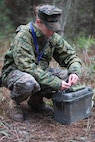 Cpl. Heather L. Haglin, a combat engineer with 8th Engineer Support Battalion, 2nd Marine Logistics Group, prepares a simulated improvised explosive device during the unit’s dismounted patrol training aboard Camp Lejeune, N.C., Dec. 13, 2012. The unit used the IED as part of a network of defensive measures designed to counter an attack from fellow Marines during three days of simulated ambushes and patrols.